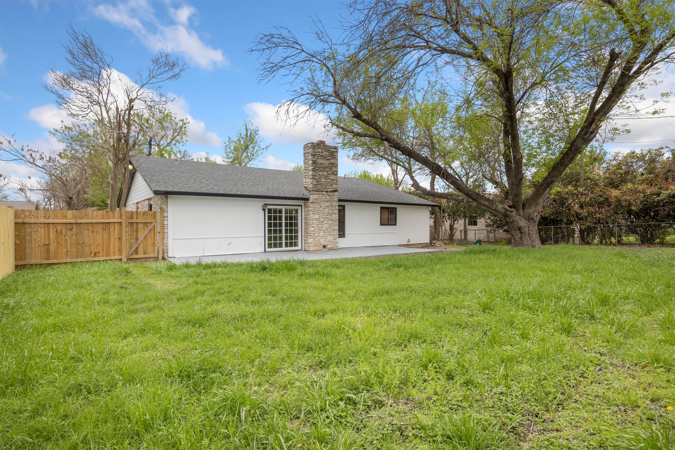 502 Pin Tail Lane Taylor, TX 76574 - Photo 23 of 26 Expansive green lawn with a mature tree