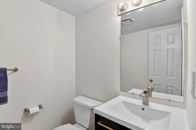 a bathroom with a sink toilet and a mirror