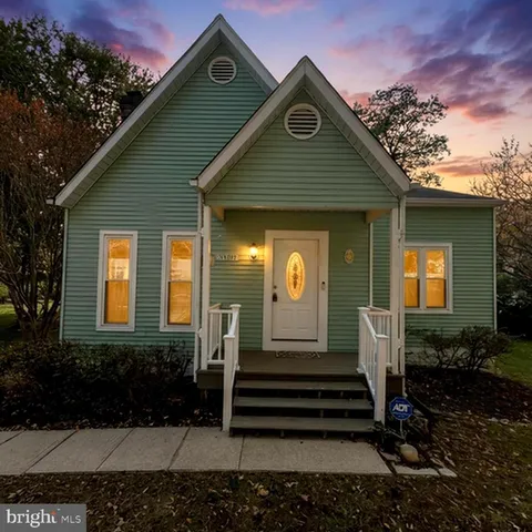 a picture of a room with a floor to a white wall and a refrigerator