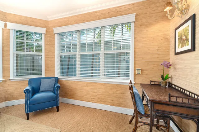 a bedroom with furniture and a large window