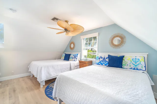 a view of swimming pool with a small yard and large tree