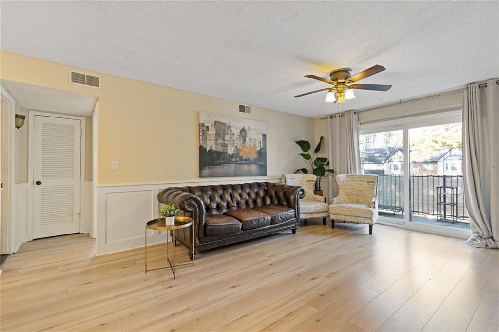 6851 Roswell Road, Unit N9 Atlanta, GA 30328 - Photo 3 of 16 a living room with furniture and wooden floor