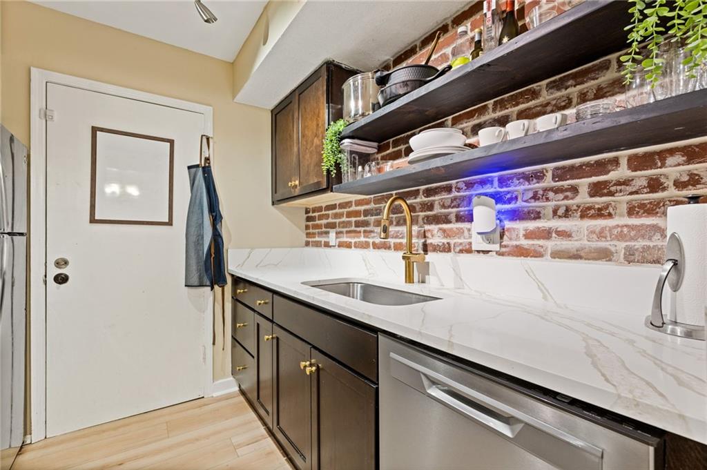 6851 Roswell Road, Unit N9 Atlanta, GA 30328 - Photo 9 of 16 a kitchen with a sink and a refrigerator