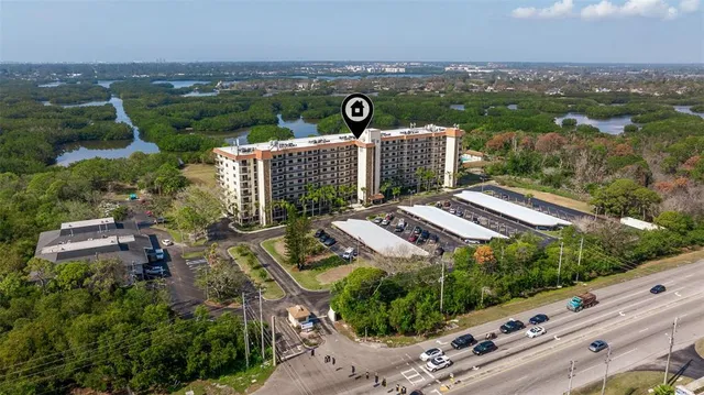 a street sign on a wall with a tall building