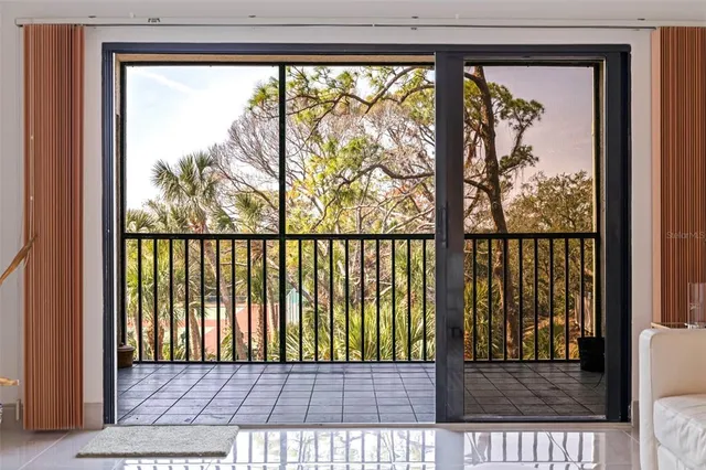 a living room with furniture and a large window with outer view