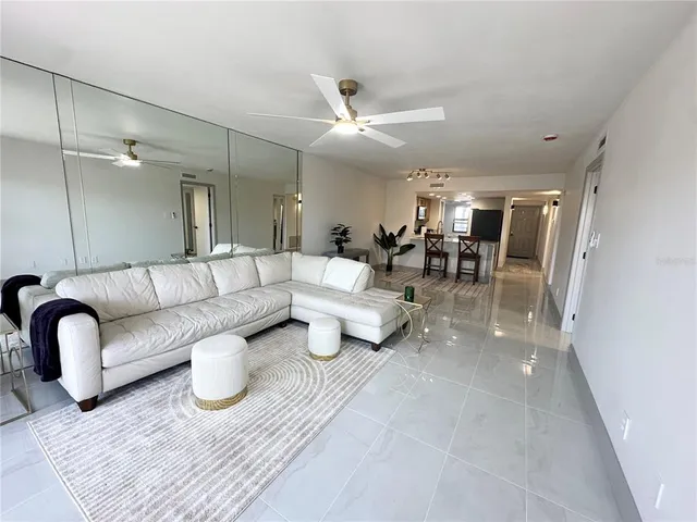 a view of a hallway with wooden floor and a bathroom
