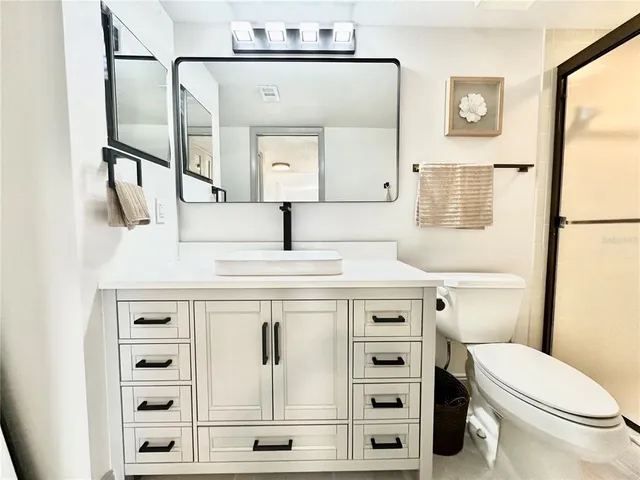an aerial view of green landscape with trees houses and lake view