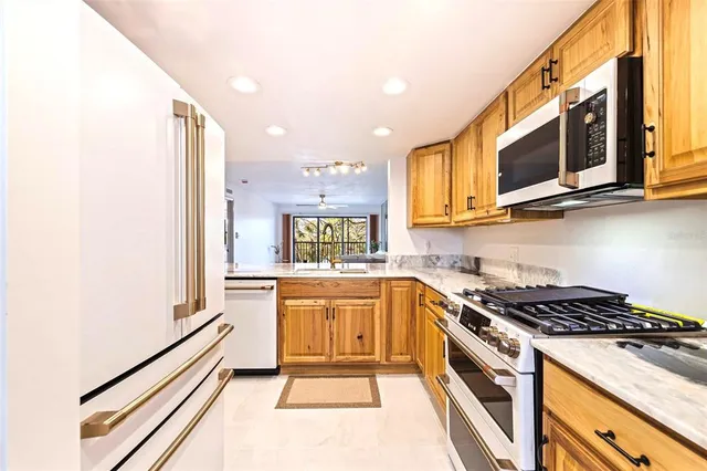 a kitchen with stainless steel appliances granite countertop a stove and a microwave