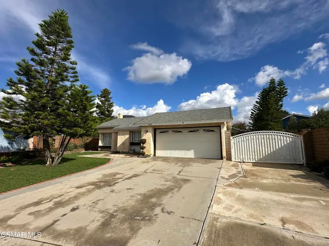 a view of a house with a yard and garage