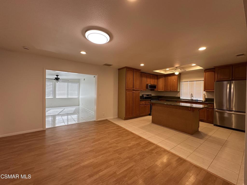 6495 Hope Street Simi Valley, CA 93063 - Photo 13 of 33 a open kitchen with kitchen island a sink a stove and refrigerator