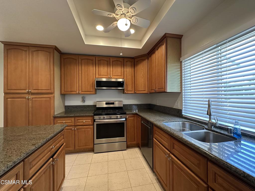 6495 Hope Street Simi Valley, CA 93063 - Photo 8 of 33 a kitchen with stainless steel appliances granite countertop a sink counter space cabinets and a window