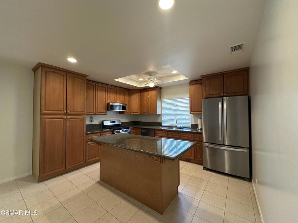 6495 Hope Street Simi Valley, CA 93063 - Photo 9 of 33 a kitchen with stainless steel appliances granite countertop a refrigerator a sink and a stove
