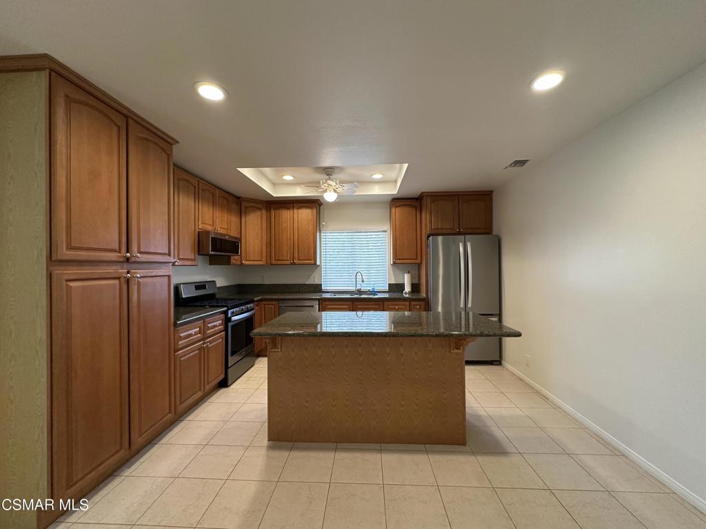 6495 Hope Street Simi Valley, CA 93063 - Photo 10 of 33 a kitchen with stainless steel appliances granite countertop a refrigerator a sink and a stove
