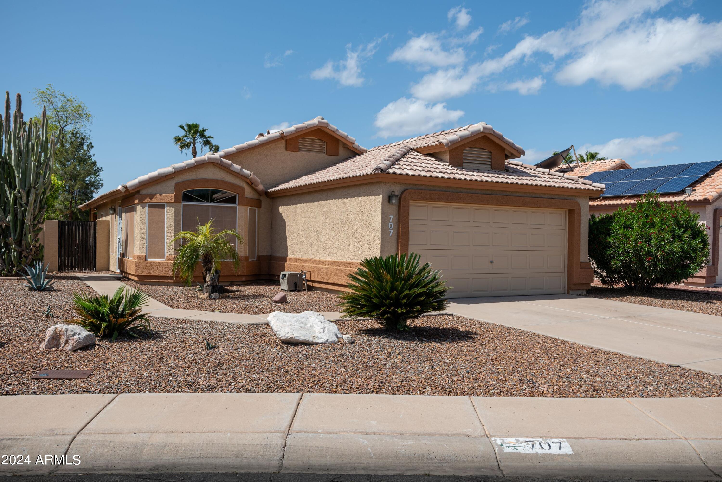 707 West Baylor Lane Gilbert, AZ 85233 - Photo 1 of 14 a front view of a house with a yard and garage