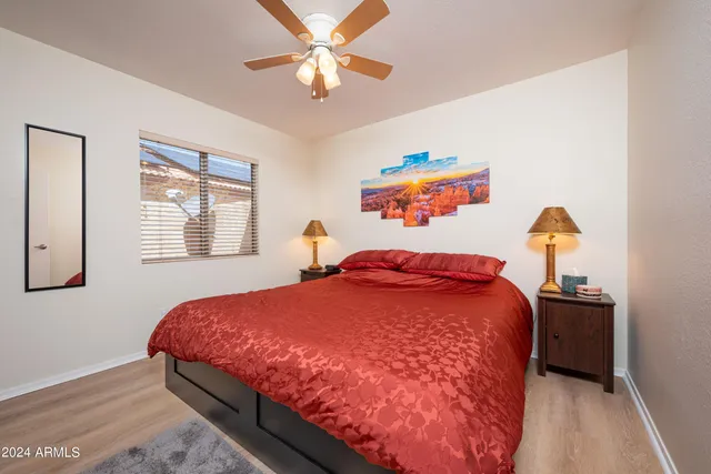 a bedroom with a bed and a chandelier