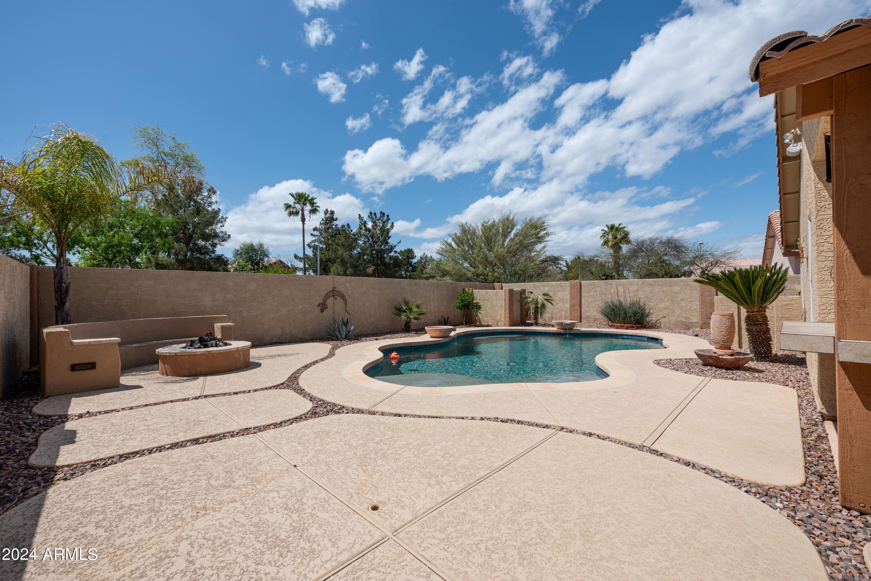 707 West Baylor Lane Gilbert, AZ 85233 - Photo 14 of 14 a backyard of a house with table and chairs