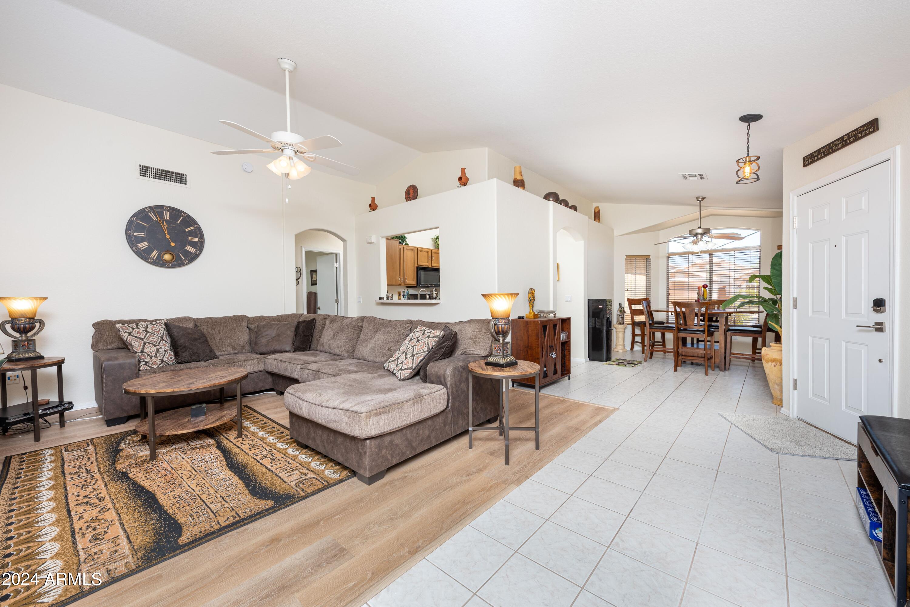 707 West Baylor Lane Gilbert, AZ 85233 - Photo 3 of 14 a living room with furniture kitchen view and a chandelier