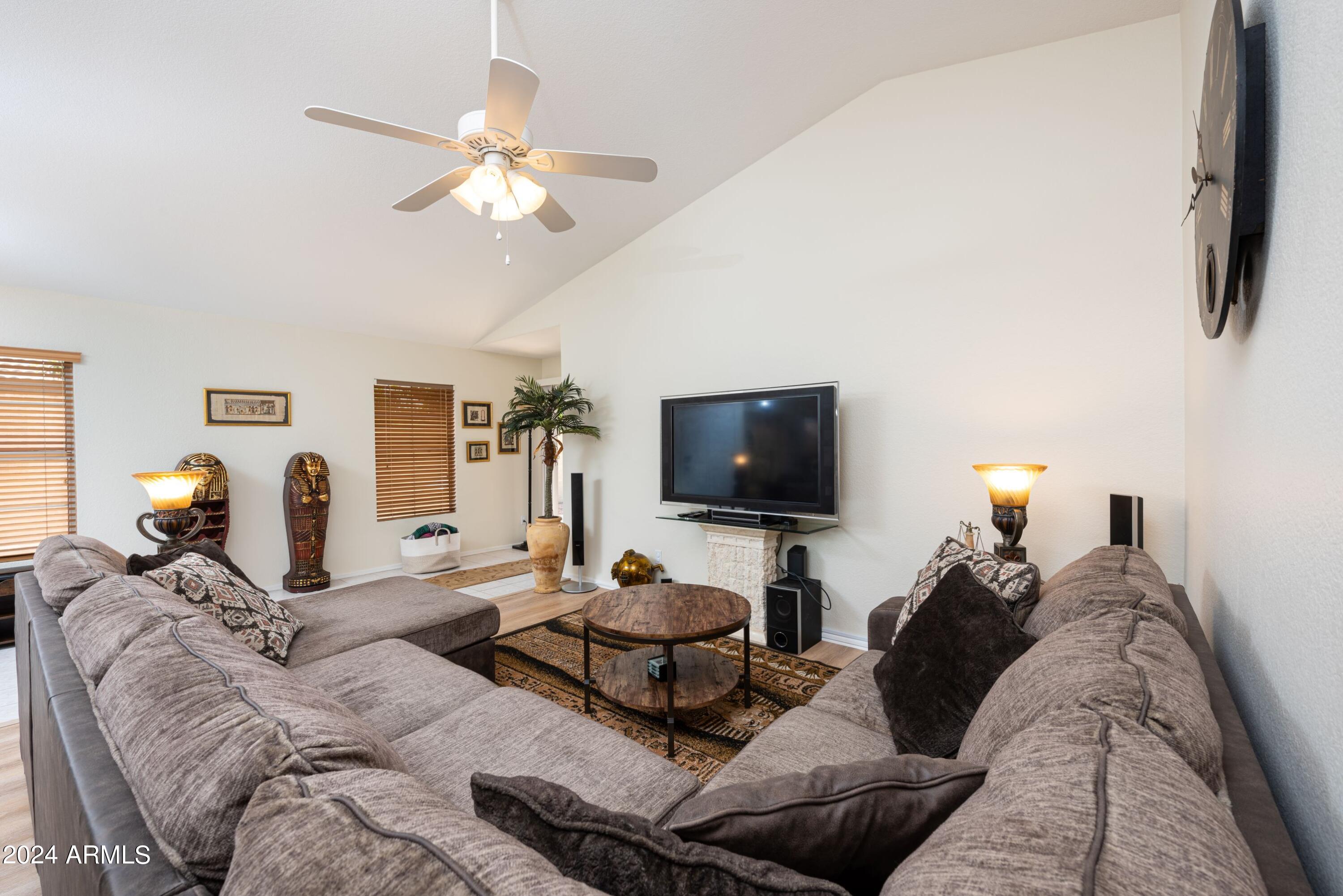 707 West Baylor Lane Gilbert, AZ 85233 - Photo 5 of 14 a living room with furniture a flat screen tv and a window
