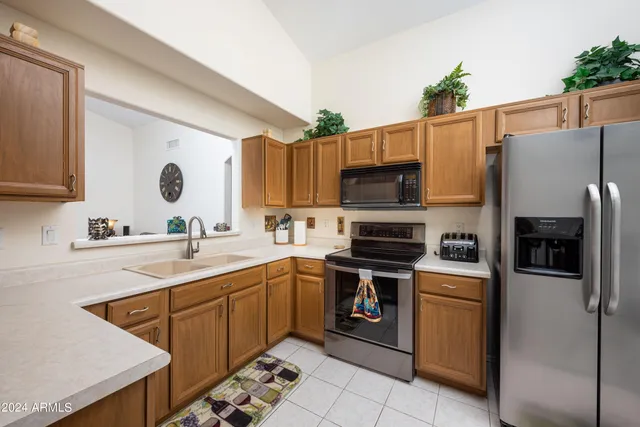 a kitchen with a sink a stove and refrigerator