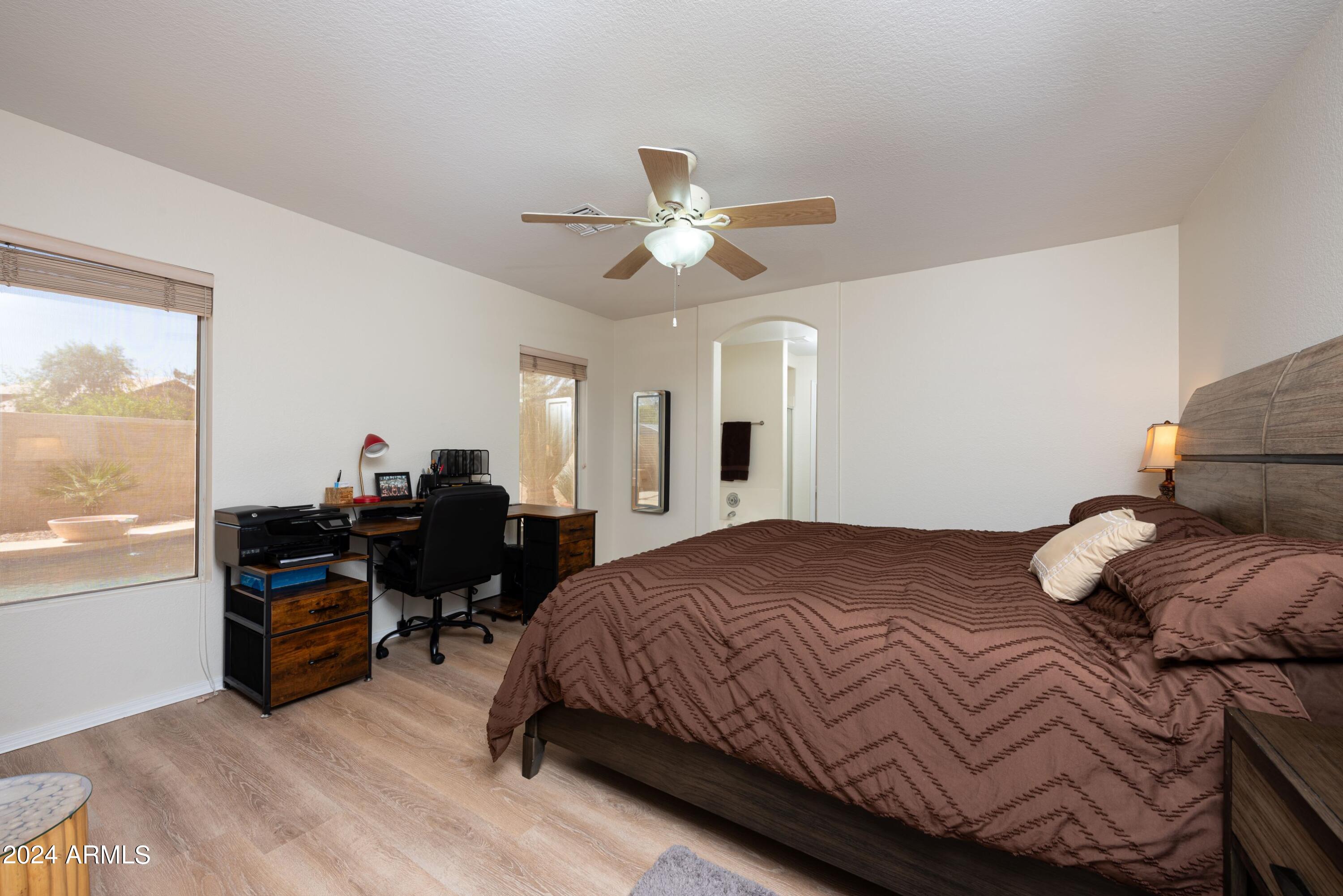707 West Baylor Lane Gilbert, AZ 85233 - Photo 8 of 14 a bedroom with a bed and a chandelier