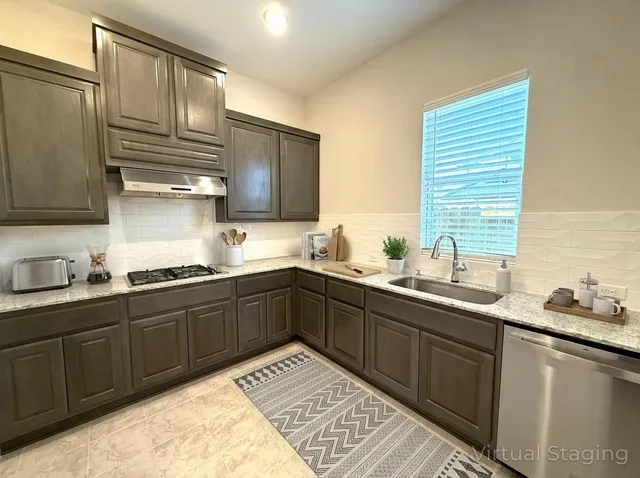 a kitchen with a sink stove and cabinets