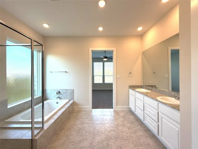 a spacious bathroom with a bathtub and a shower