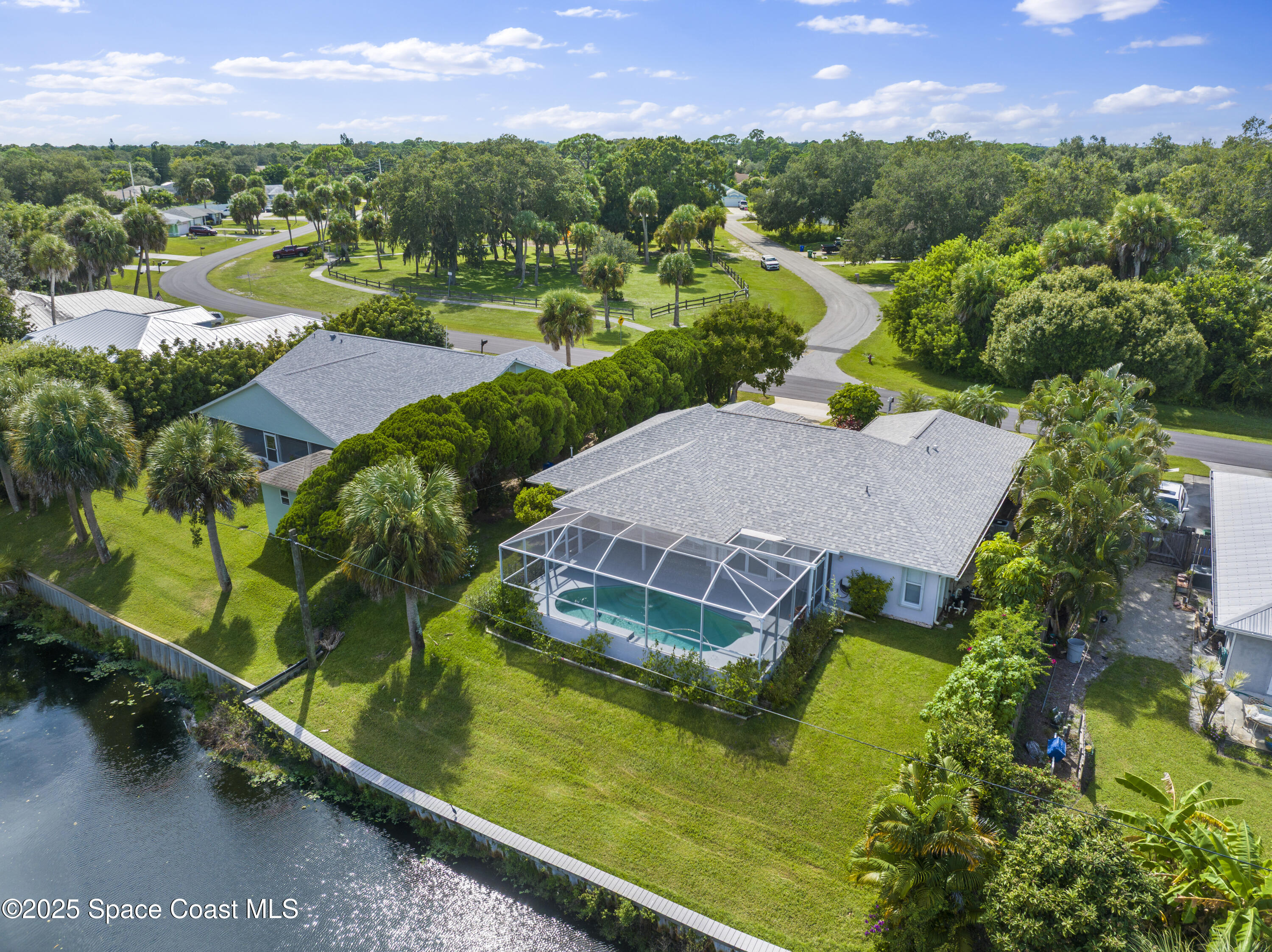 an aerial view of residential houses with outdoor space and swimming pool