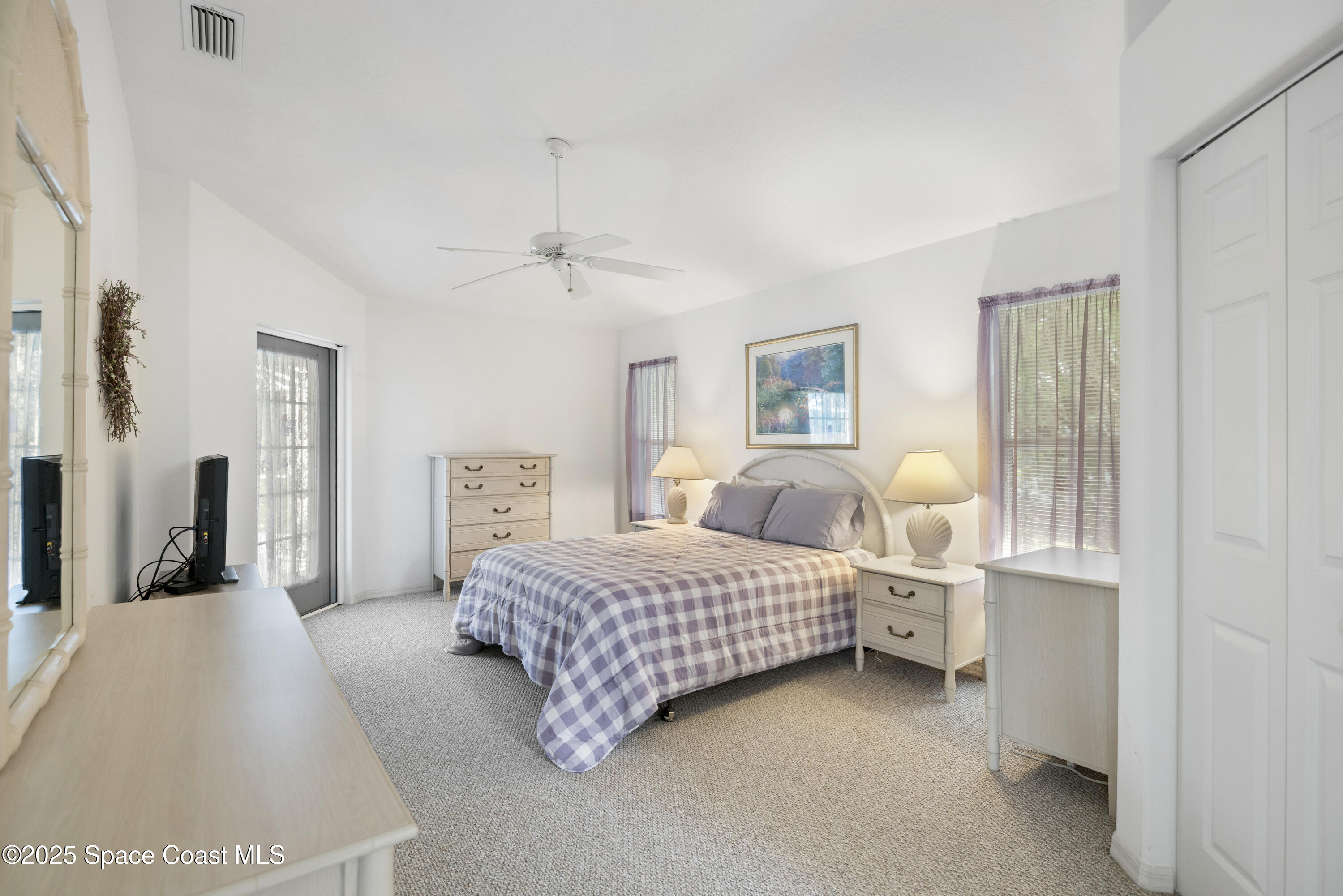 1253 George Street Sebastian, FL 32958 - Photo 18 of 37 a bedroom with a bed and a lamp