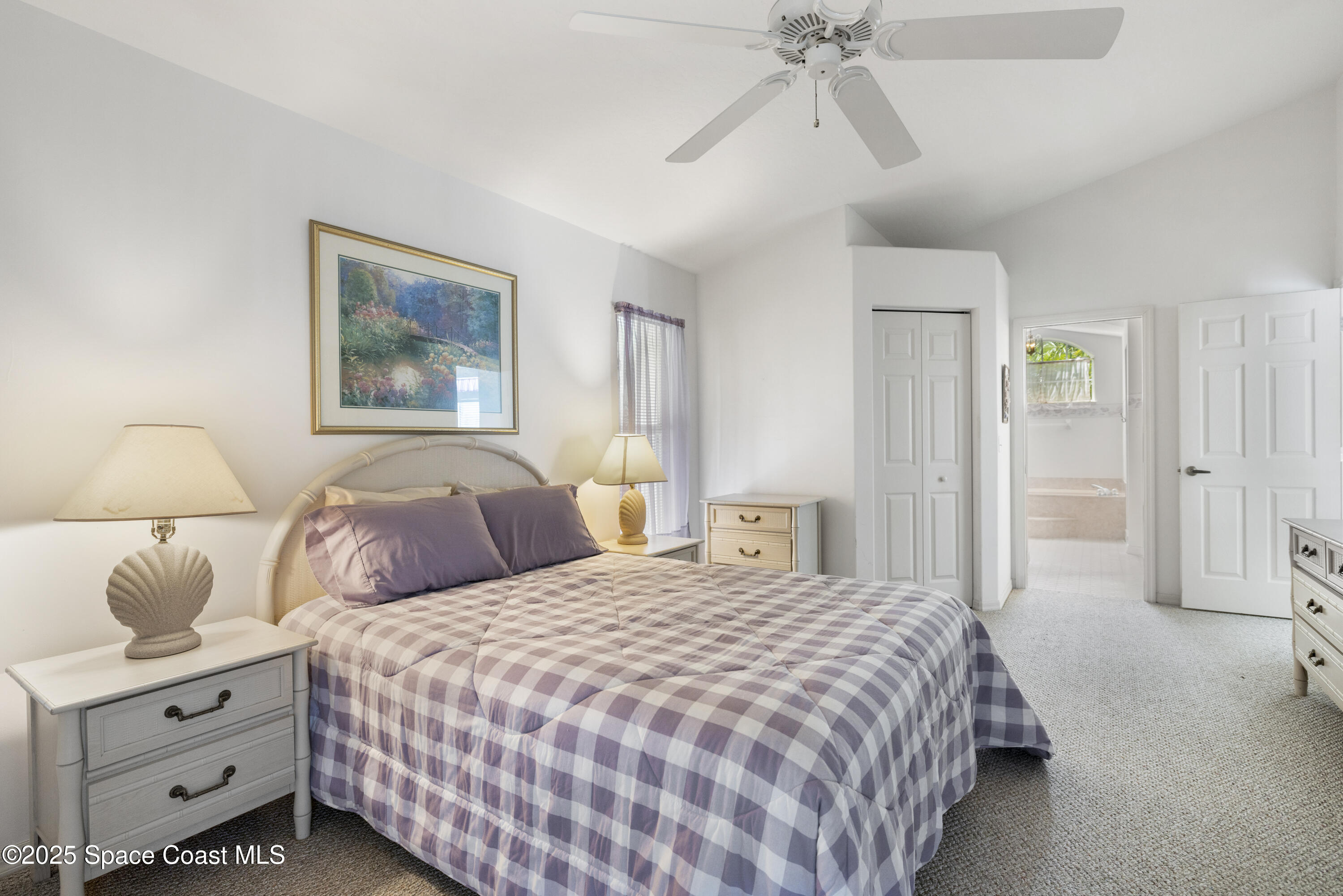 1253 George Street Sebastian, FL 32958 - Photo 19 of 37 a bedroom with a bed and a chandelier