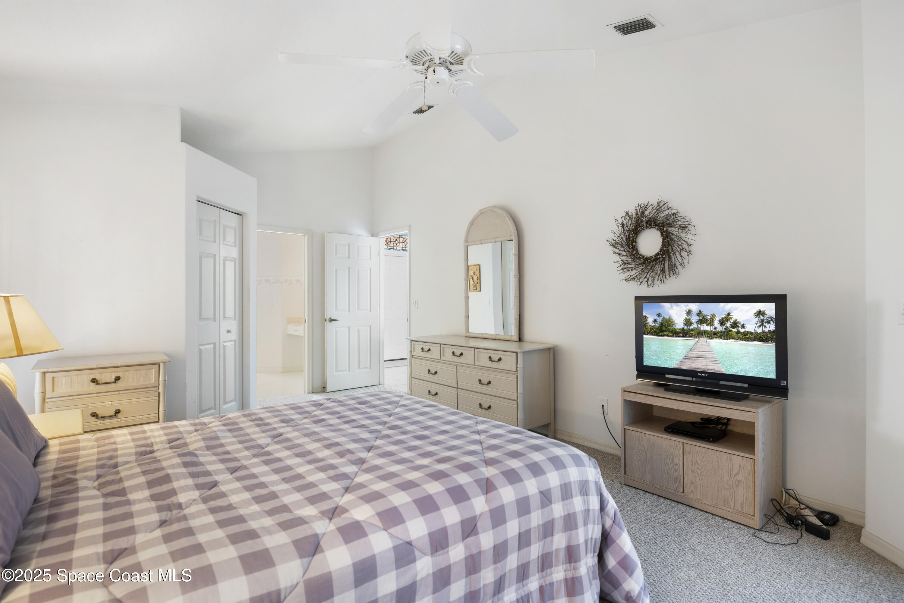 1253 George Street Sebastian, FL 32958 - Photo 20 of 37 a bedroom with a bed and a flat screen tv