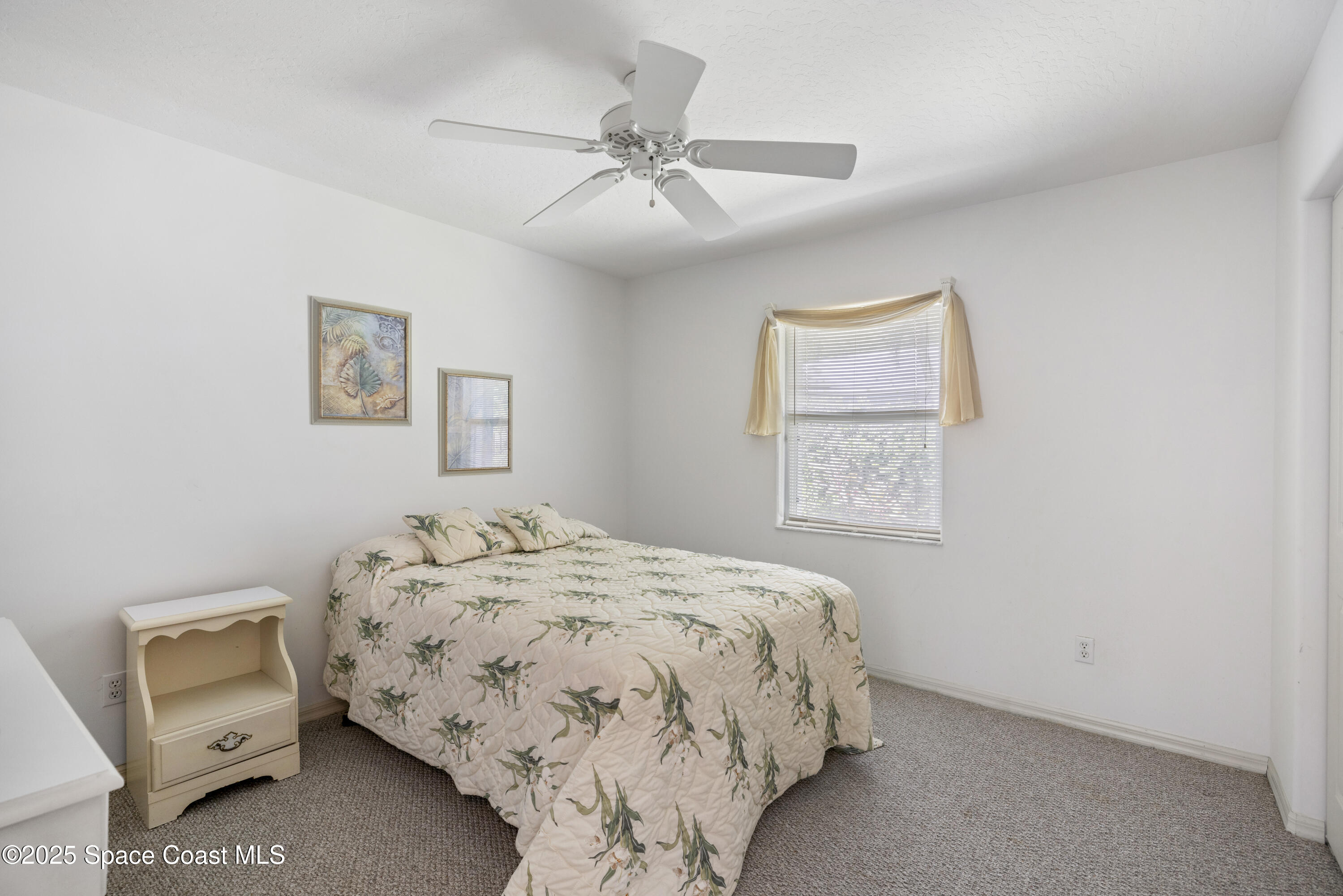 1253 George Street Sebastian, FL 32958 - Photo 24 of 37 a bedroom with a bed and a dresser