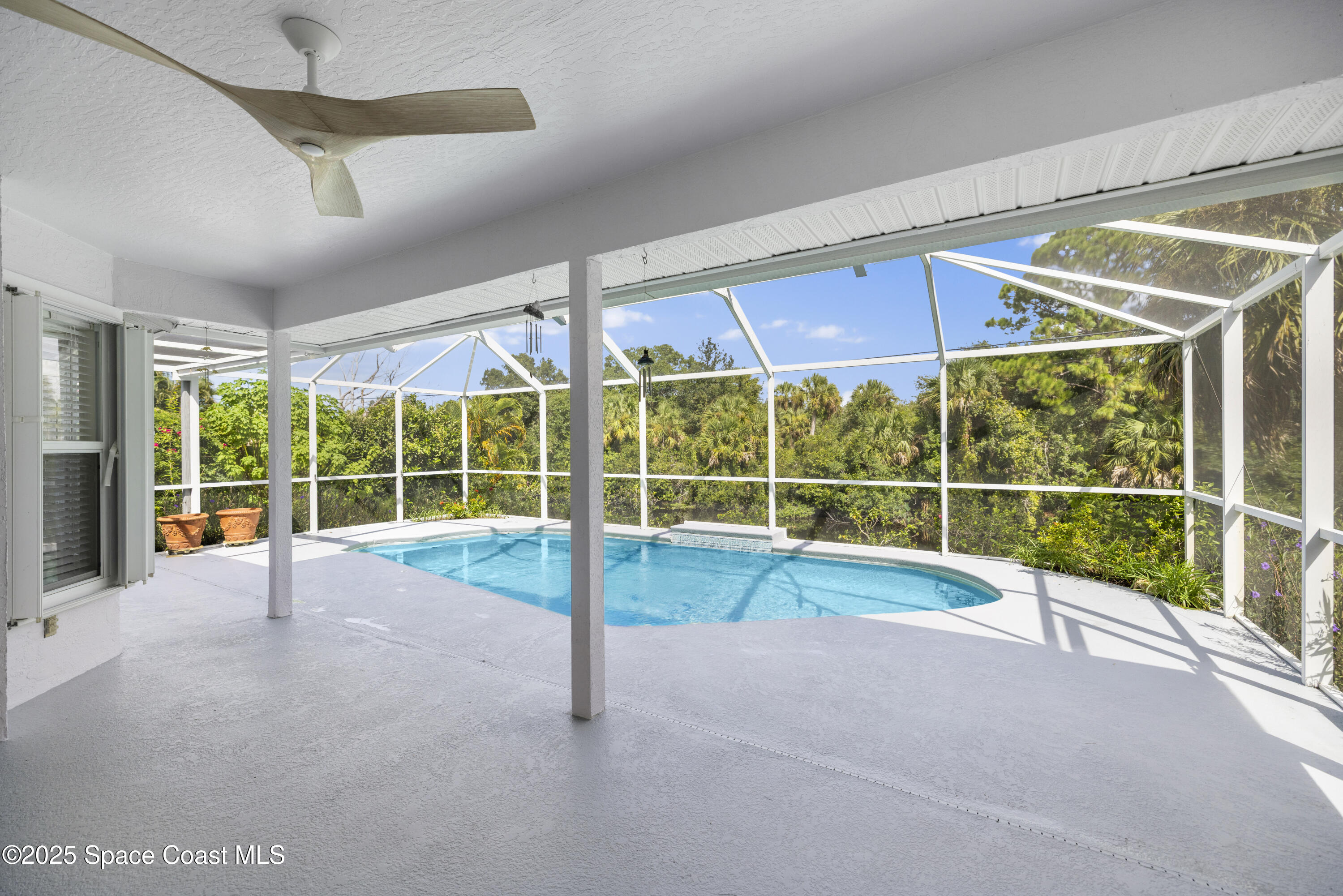 1253 George Street Sebastian, FL 32958 - Photo 29 of 37 a view of an empty room with wooden floor and windows