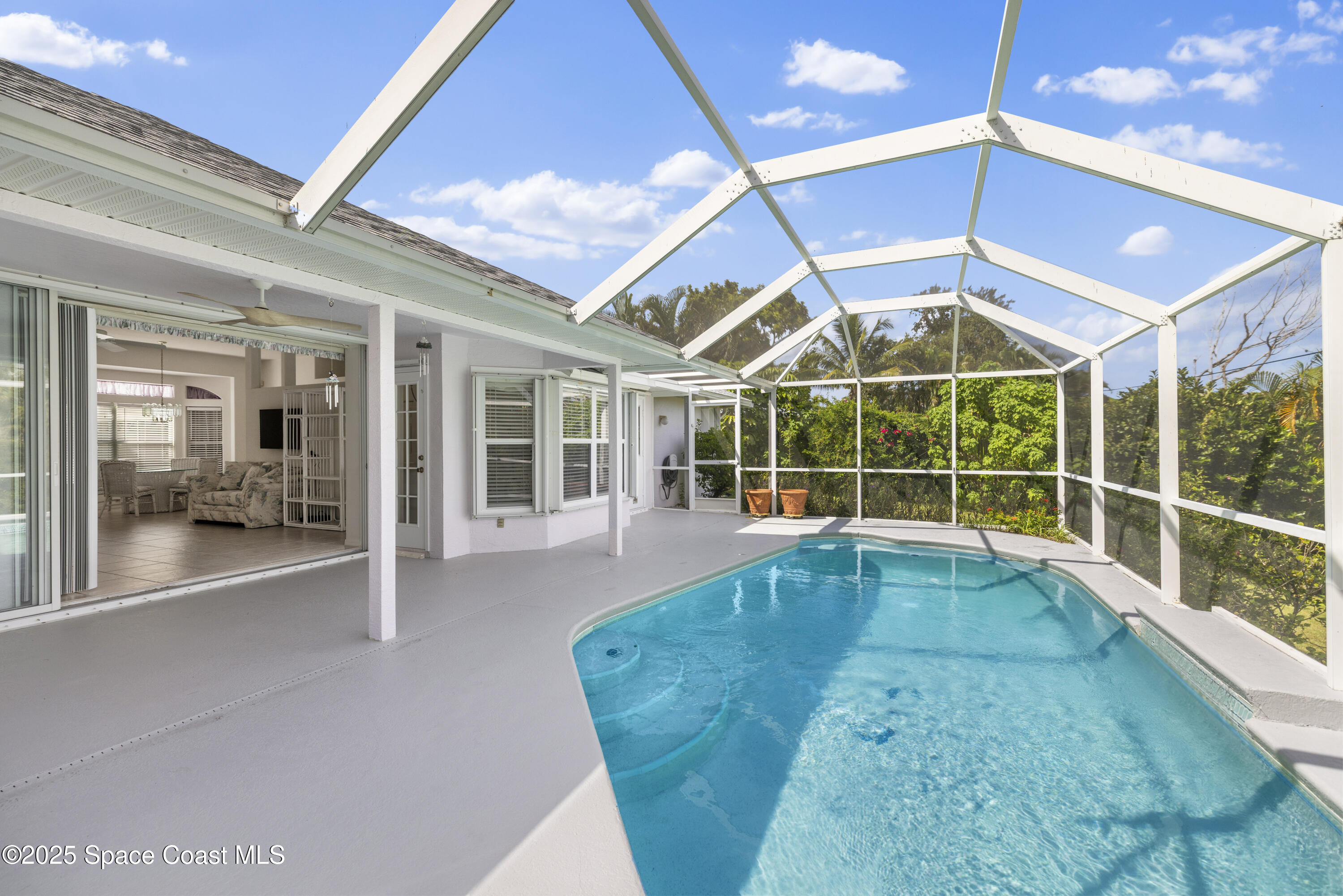 1253 George Street Sebastian, FL 32958 - Photo 3 of 37 a view of a living room with a large window and chandelier