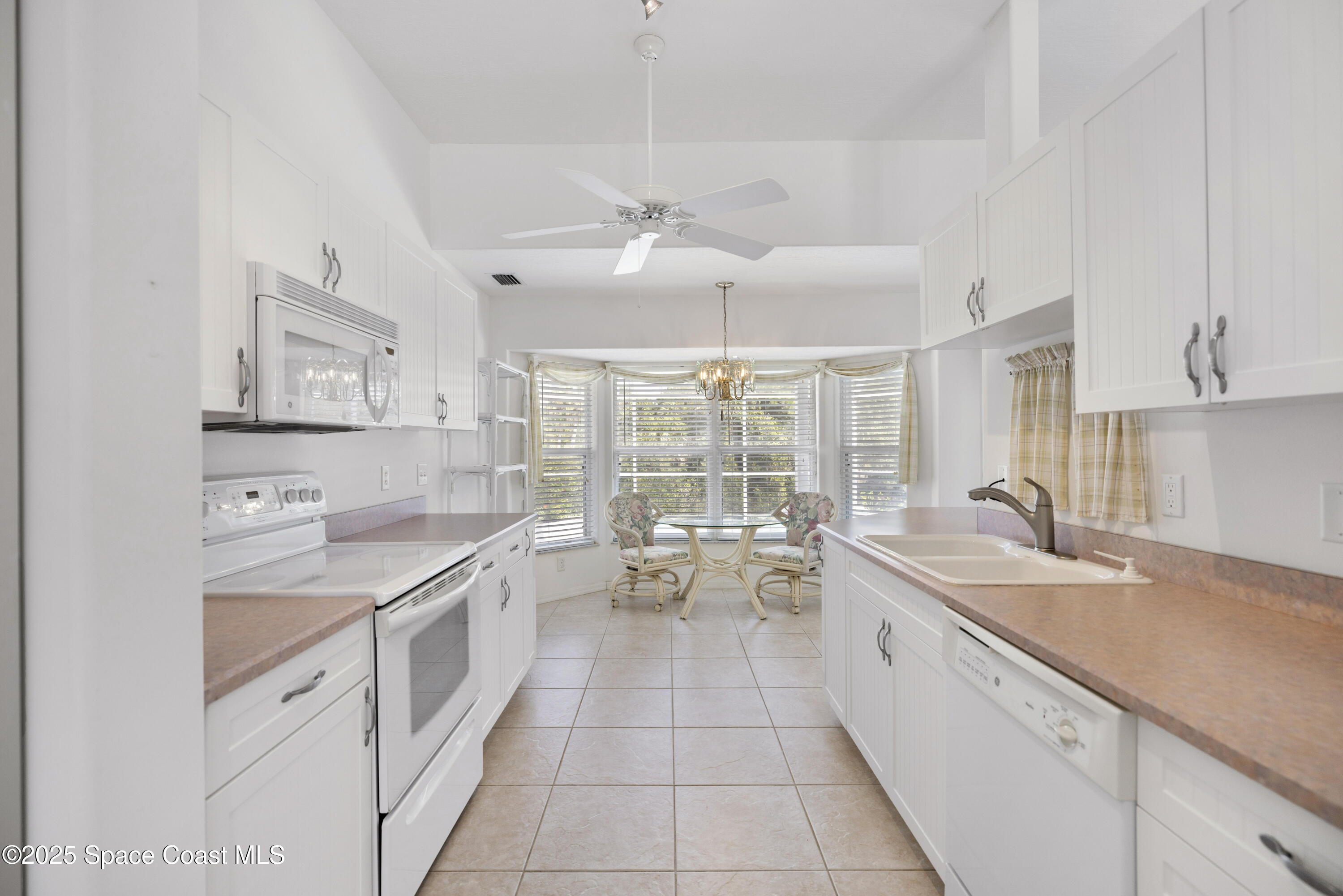 1253 George Street Sebastian, FL 32958 - Photo 5 of 37 a large white kitchen with a large window