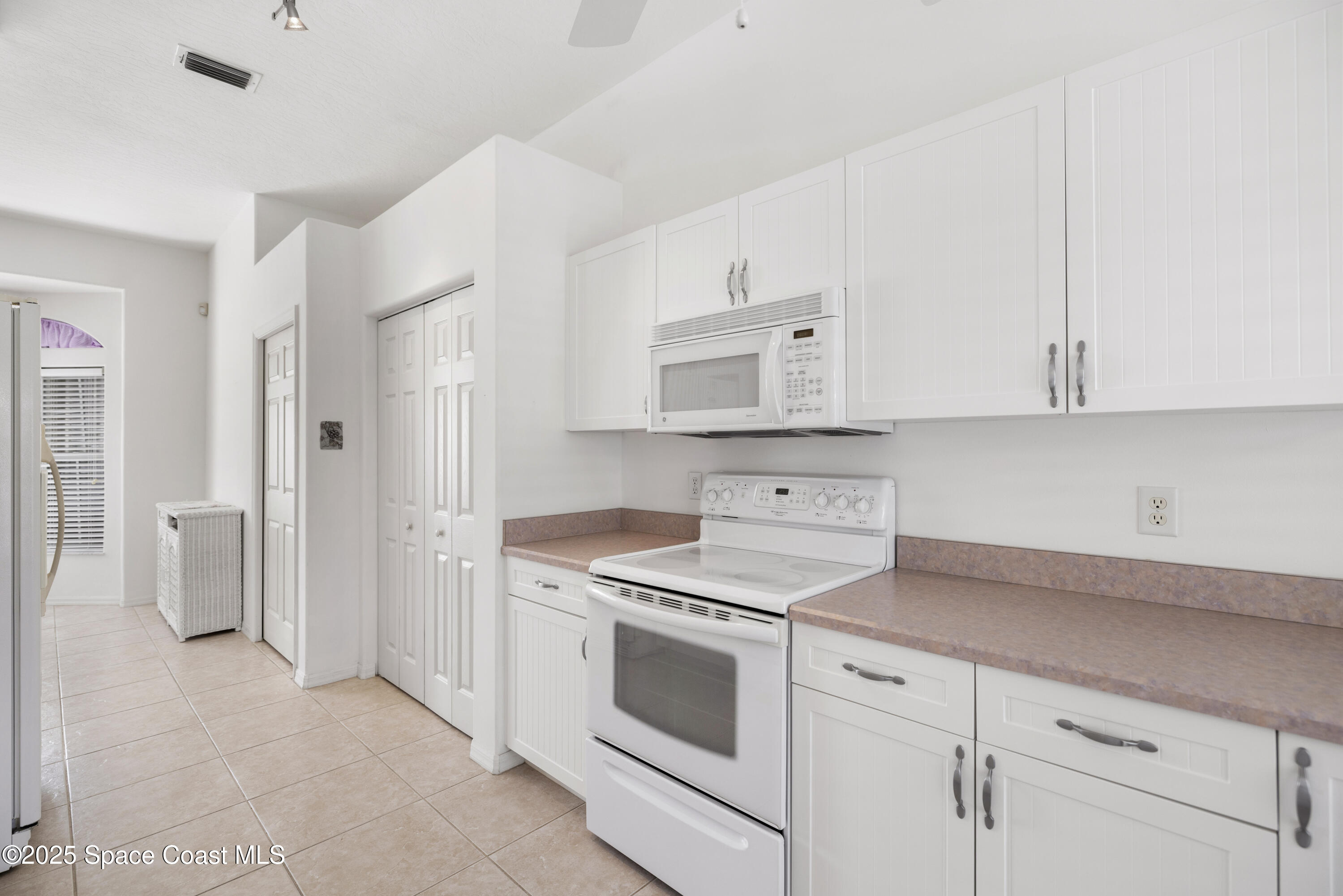 1253 George Street Sebastian, FL 32958 - Photo 7 of 37 a kitchen with stainless steel appliances white cabinets and a stove