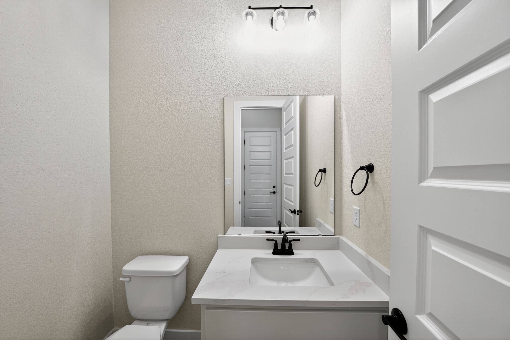 205 Three Rivers Road Georgetown, TX 78633 - Photo 25 of 32 a bathroom with a sink a toilet and a mirror