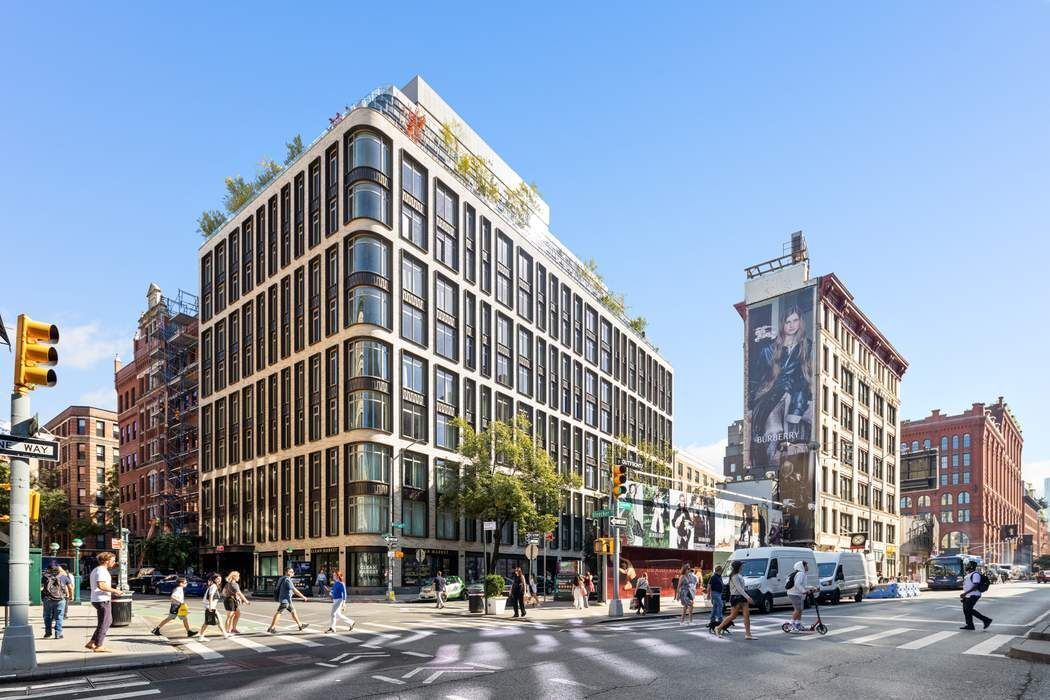 40 Bleecker Street, Unit 5D Manhattan, NY 10012 - Photo 16 of 17 a front view of a building with lot of cars and trees