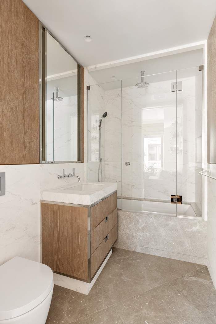 40 Bleecker Street, Unit 5D Manhattan, NY 10012 - Photo 7 of 17 a bathroom with a sink mirror toilet and bathtub