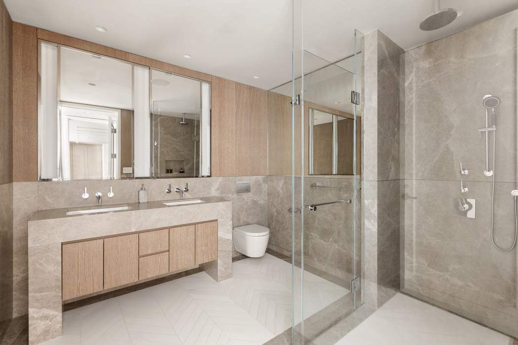 40 Bleecker Street, Unit 5D Manhattan, NY 10012 - Photo 9 of 17 a bathroom with a double vanity sink toilet and shower