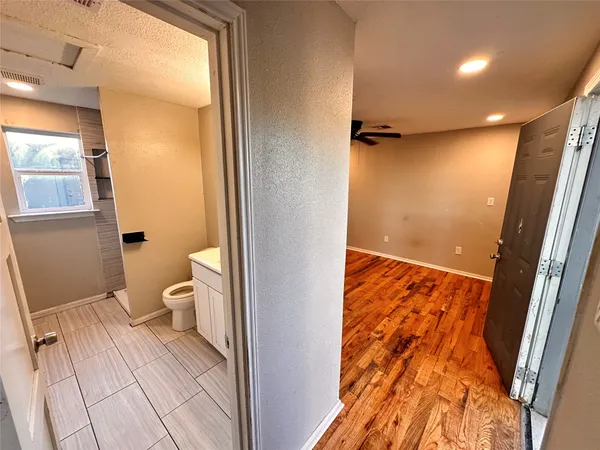 a bathroom with a toilet and a shower