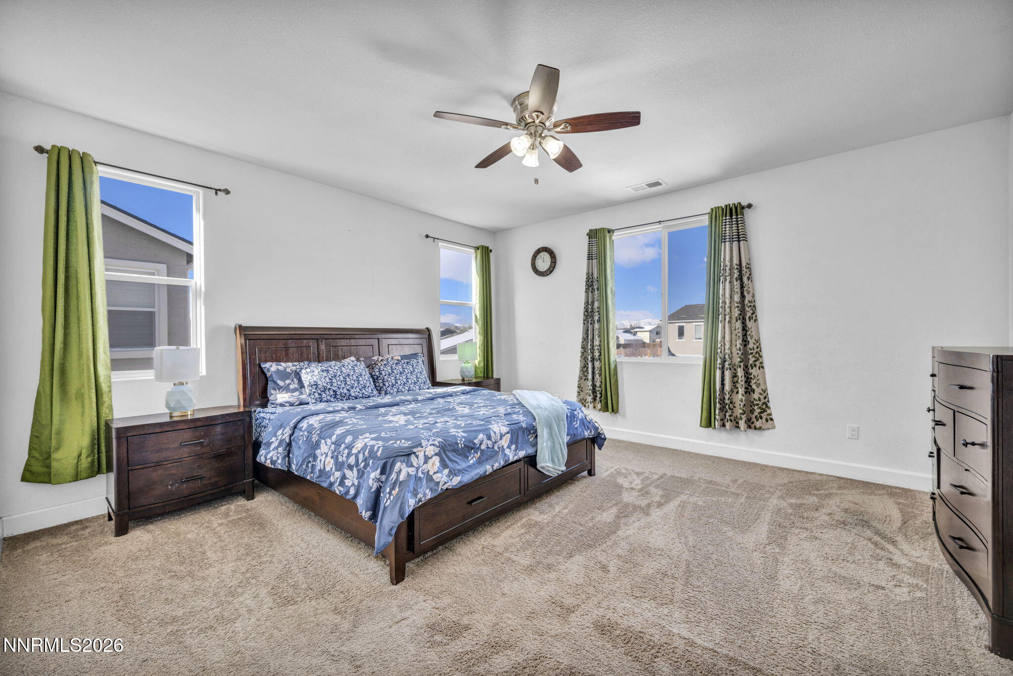 969 Estuary Circle Reno, NV 89506 - Photo 17 of 38 a spacious bedroom with a bed and a chandelier