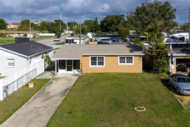 a aerial view of a house with a yard table and chairs