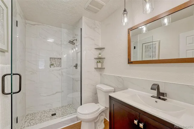 a bath tub sitting next to a white toilet and a sink