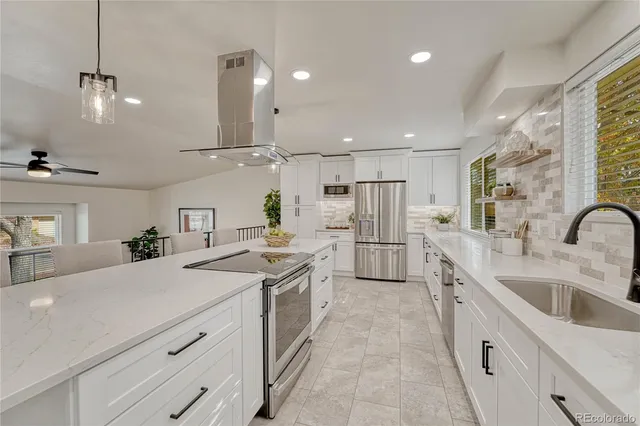 a kitchen with a sink stove and refrigerator