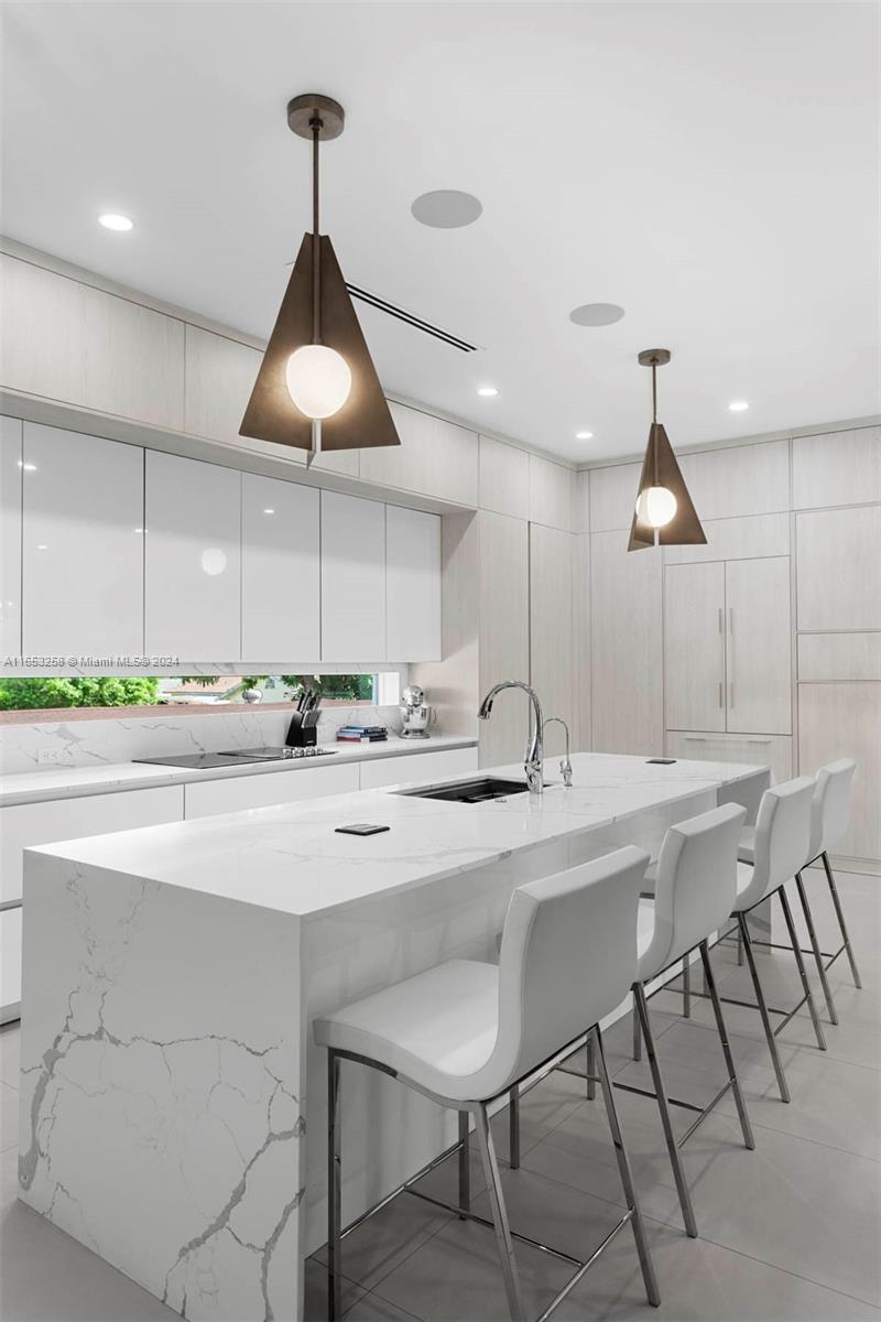 1701 Southwest 4th Avenue Miami, FL 33129 - Photo 21 of 32 a kitchen with stainless steel appliances granite countertop a sink a stove white table and chairs