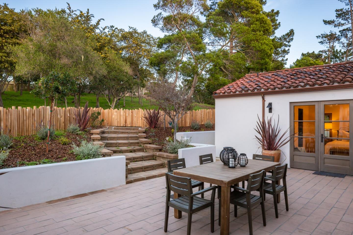 1605 Sonado Road Pebble Beach, CA 93953 - Photo 11 of 33 a view of a table and chairs in back yard of a house