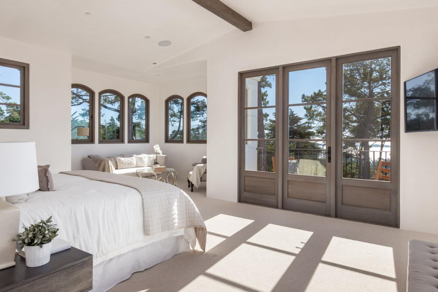 1605 Sonado Road Pebble Beach, CA 93953 - Photo 26 of 33 a large bedroom with a large bed and glass door