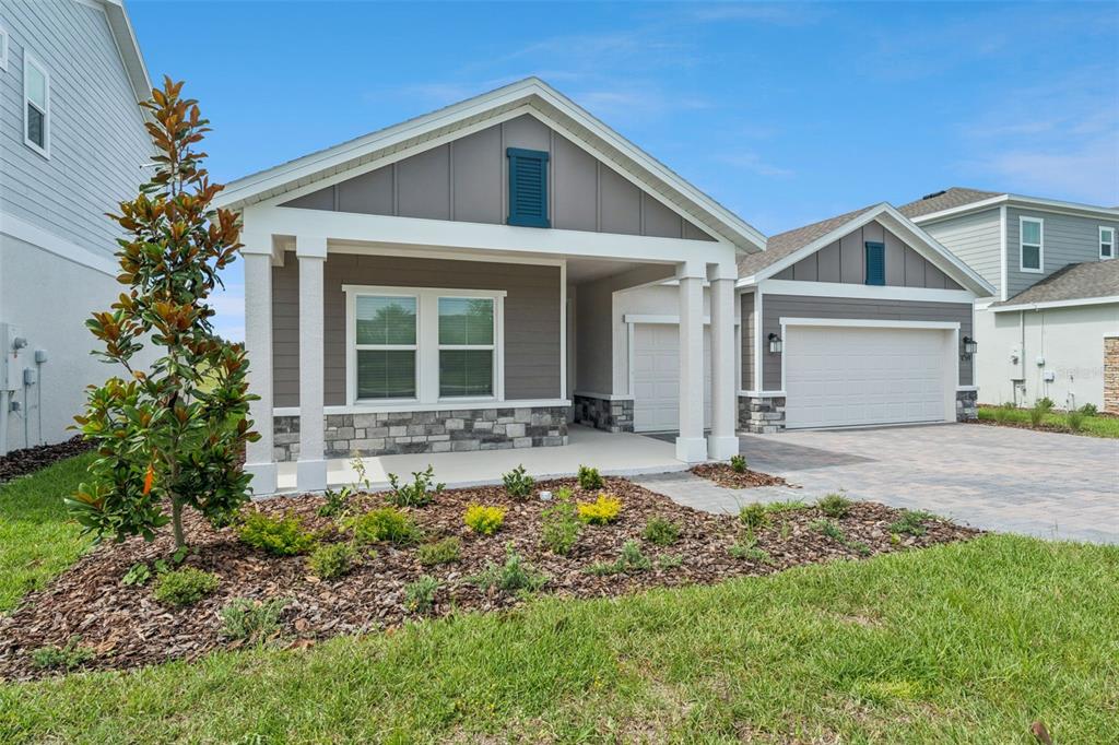 1672 Rider Rain Lane Apopka, FL 32703 - Photo 2 of 35 a front view of a house with a garden