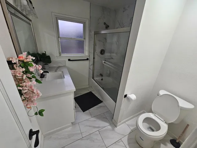 a bathroom with a shower and a sink