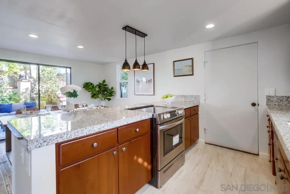 141 Sea Cliff Way Del Mar, CA 92014 - Photo 12 of 65 a kitchen with stainless steel appliances granite countertop a sink a stove a refrigerator and a counter top space